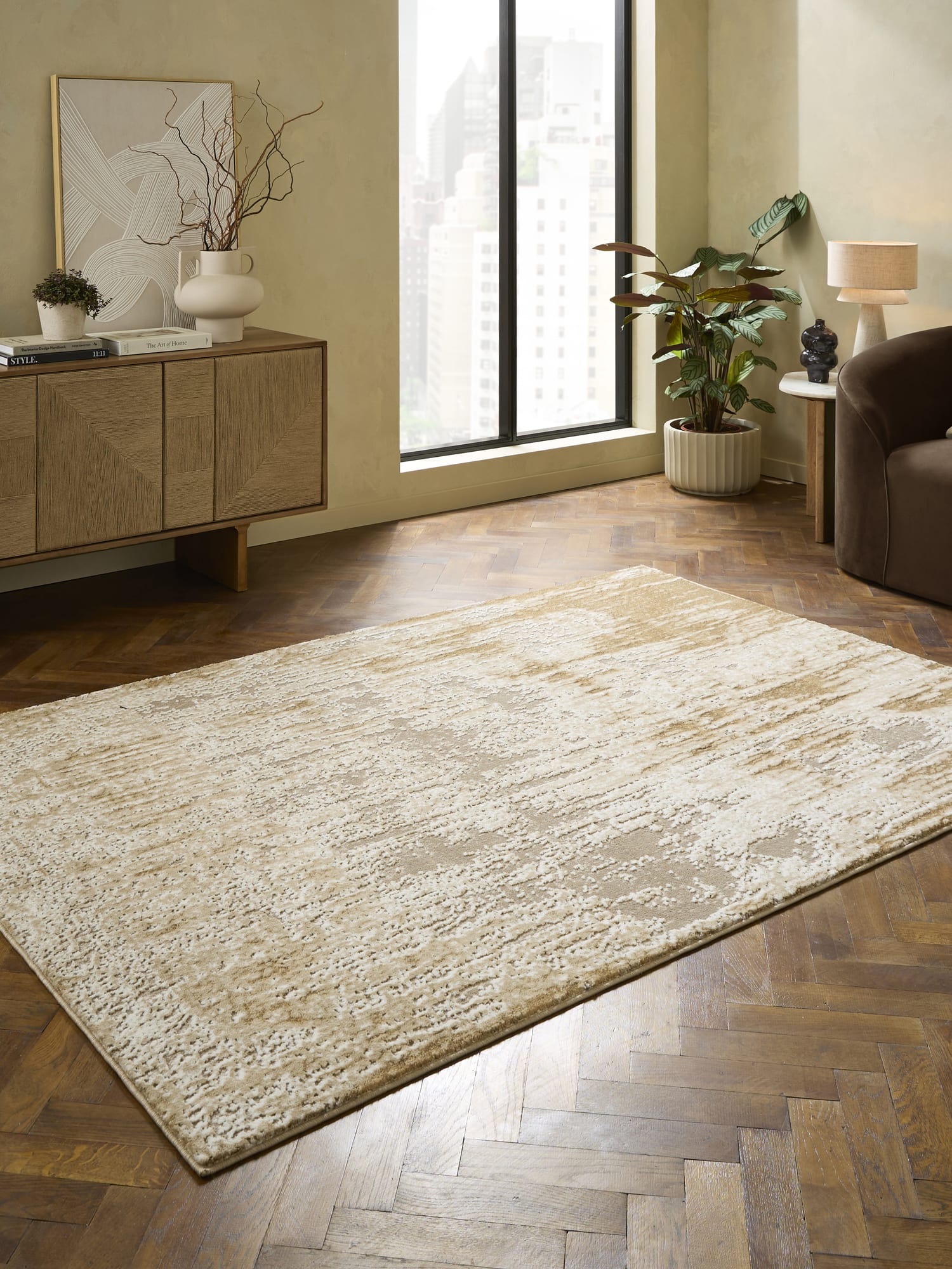 Apollo rectangular rug in cream and beige, beside a wooden sideboard and a tall window.