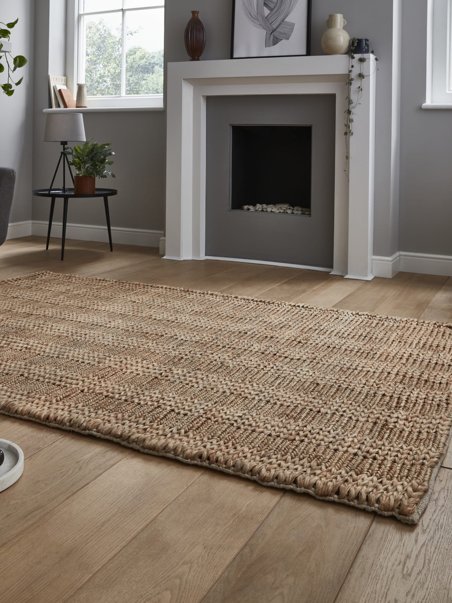 Bazaar Plain rectangular rug in natural, at a low angle showing the textured surface and edge.