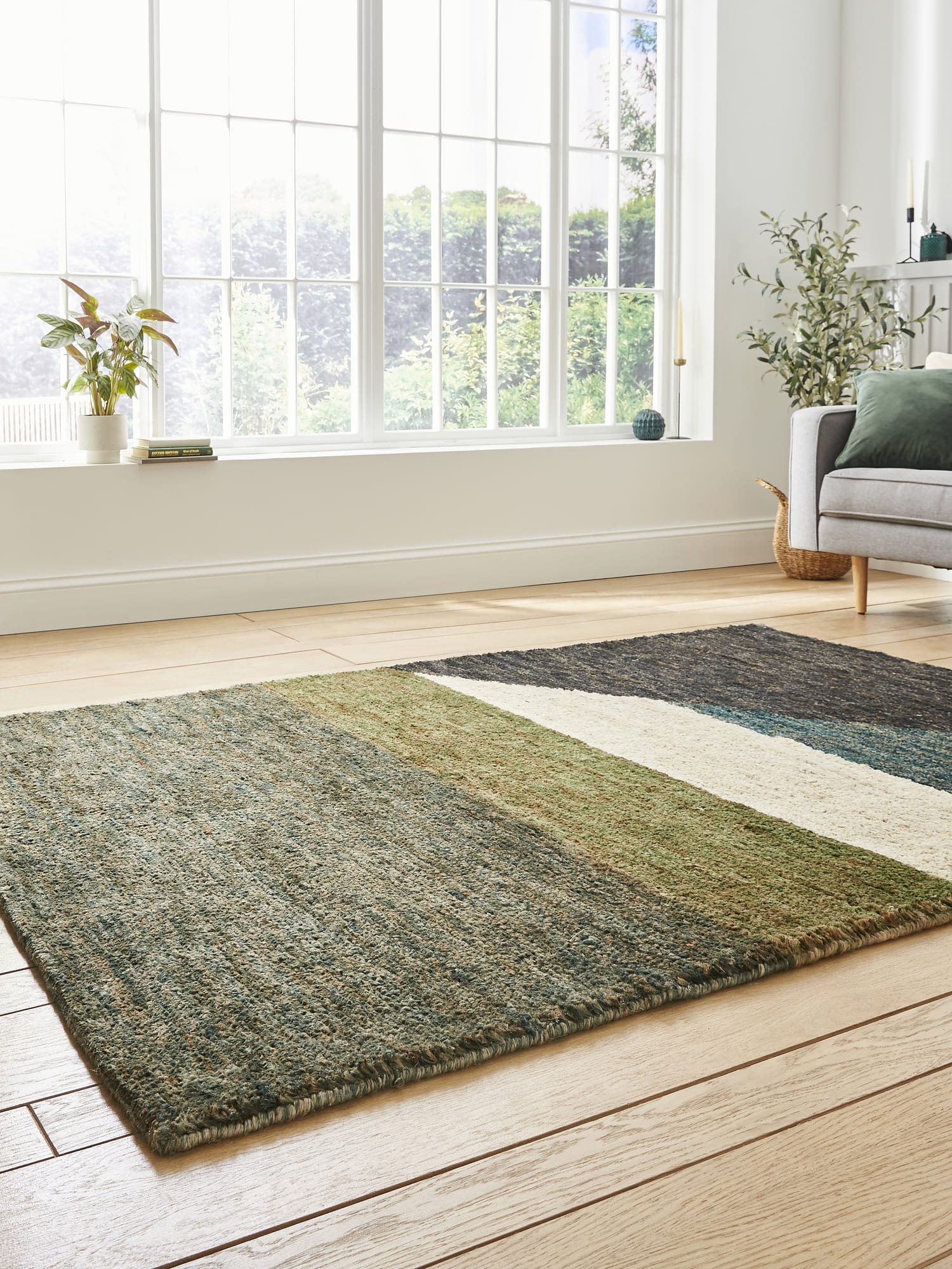 Hemp Multi Hand-Knotted Rug. Hemp rectangular rug in charcoal, teal, olive and cream, at a low angle showing the contrasting colour blocks.