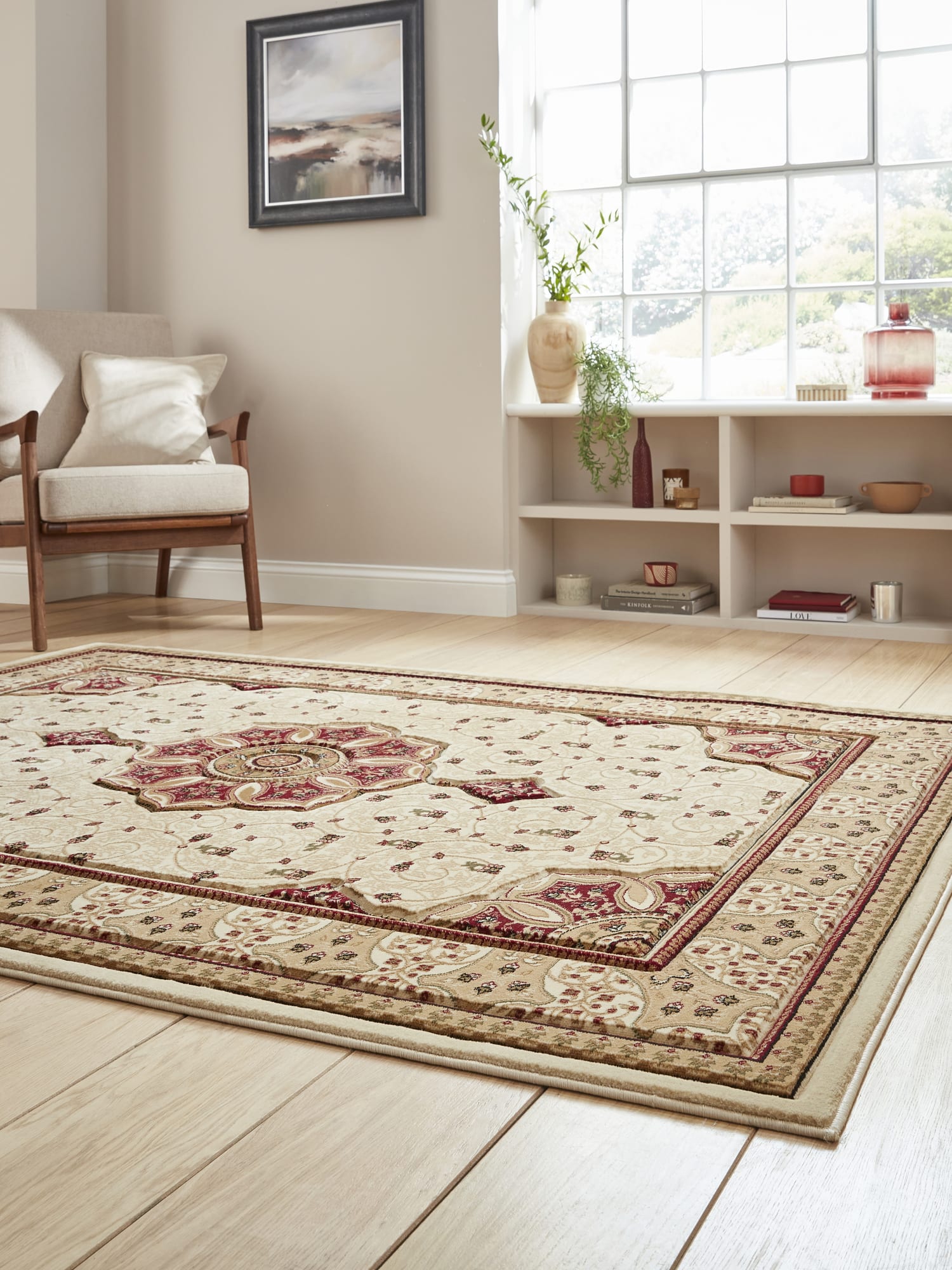 Heritage rectangular rug in cream and red, at a low angle showing the framed pattern beside a window.