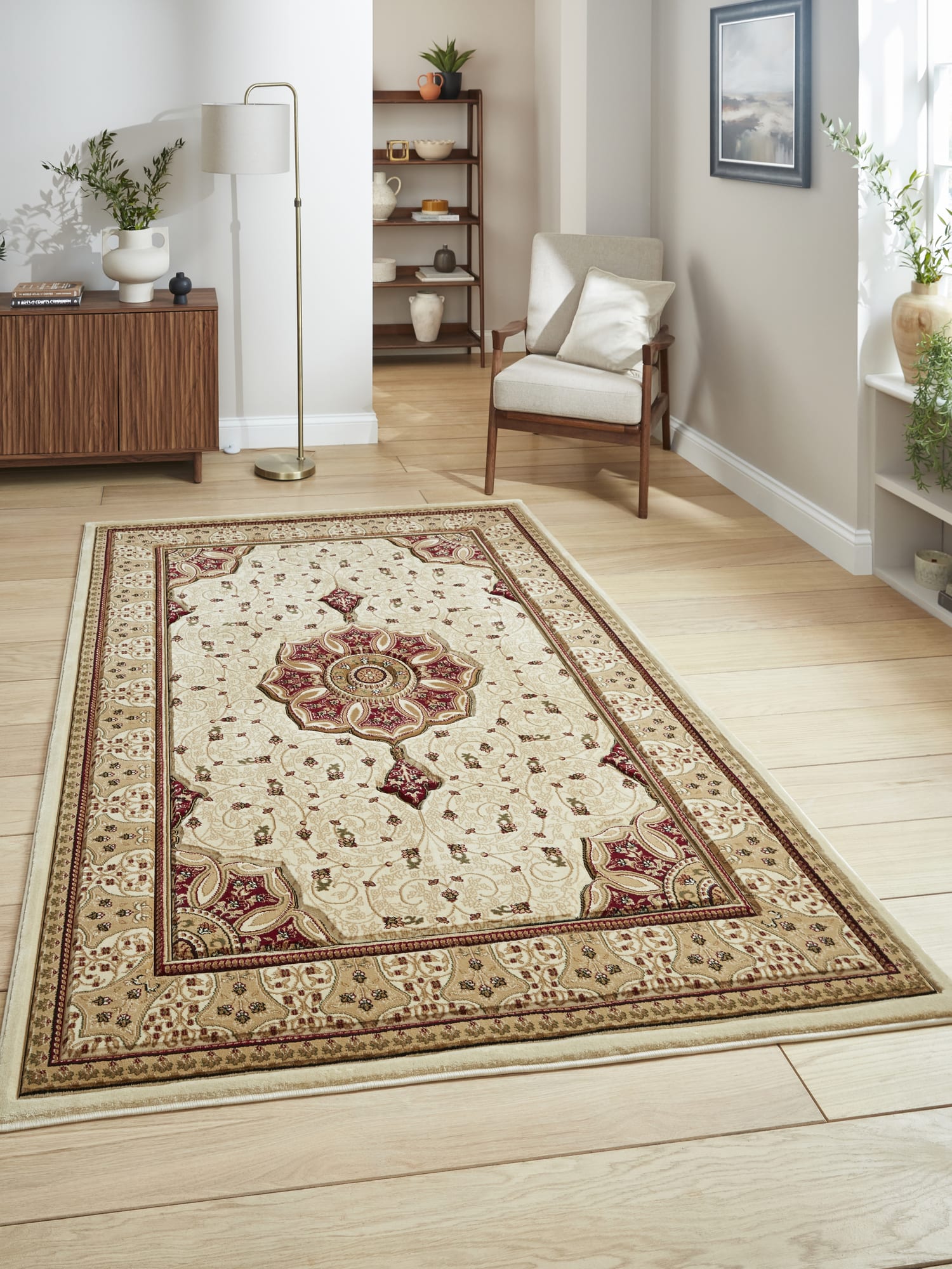 Heritage rectangular rug in cream and red, beside an armchair and wooden cabinet.