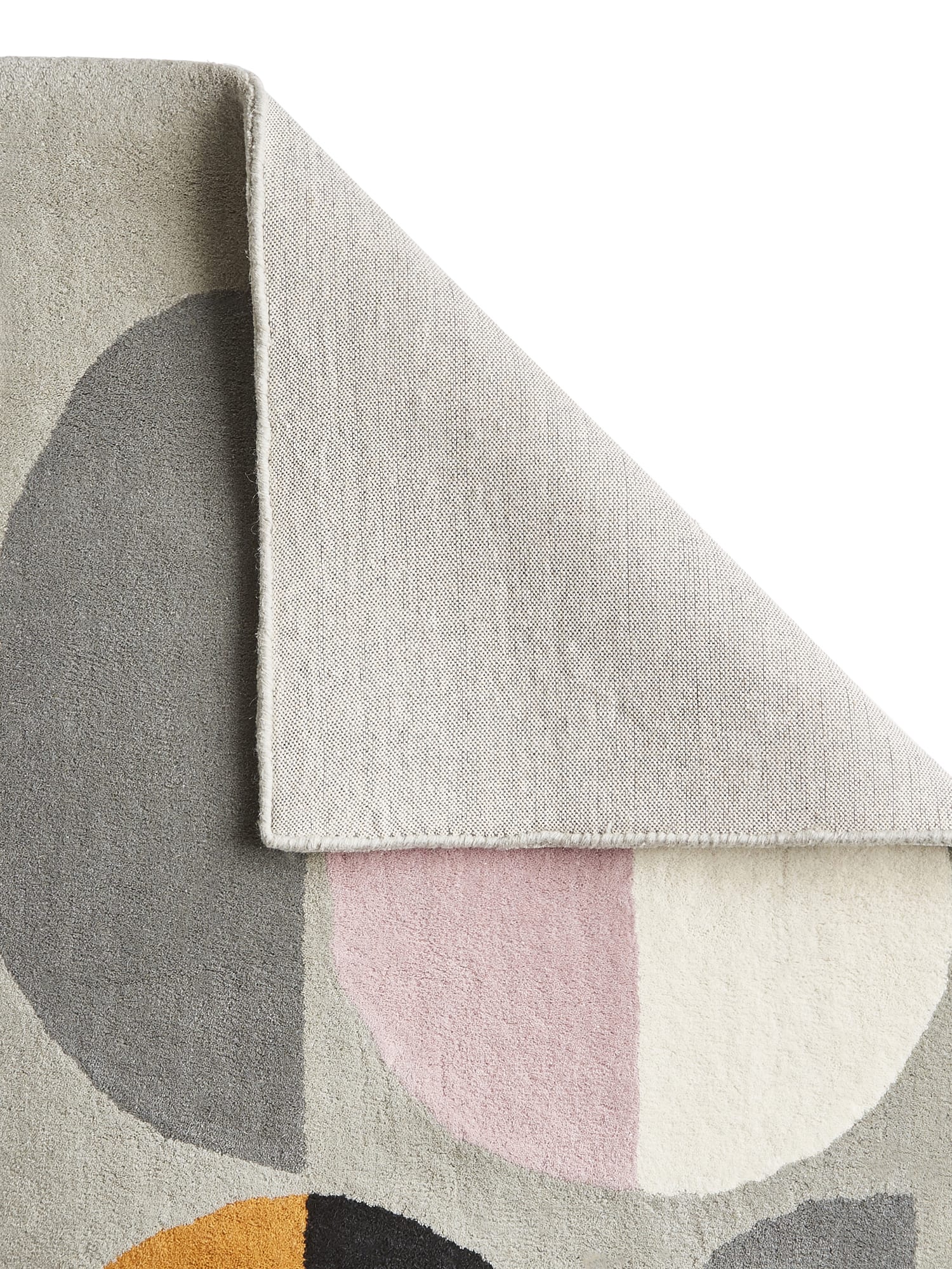 Inaluxe Composition rectangular rug in grey, black and cream with yellow, blue and pink accents, with a corner folded back to show the underside.