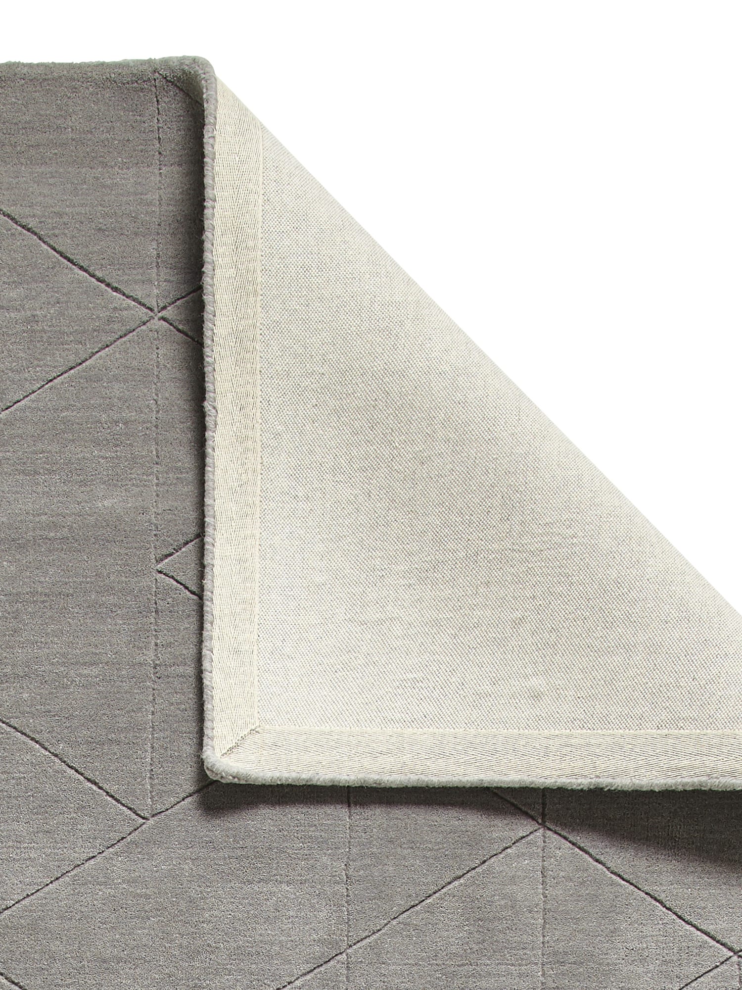 Kasbah rectangular rug in grey, with a corner folded back to show the underside.