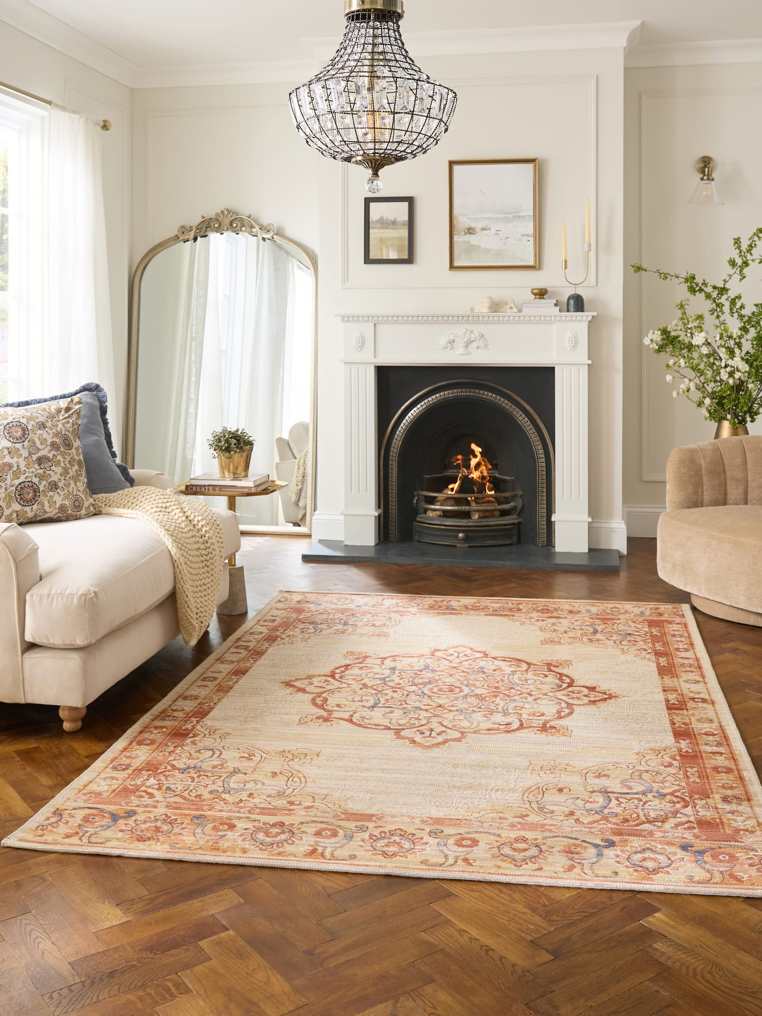 Quartz rectangular rug in cream and rust, in a room with a fireplace and parquet floor.