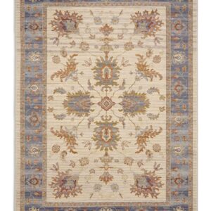 Quartz rectangular rug shown flat in ivory and blue, with branching floral motifs on an ivory field with a blue border.
