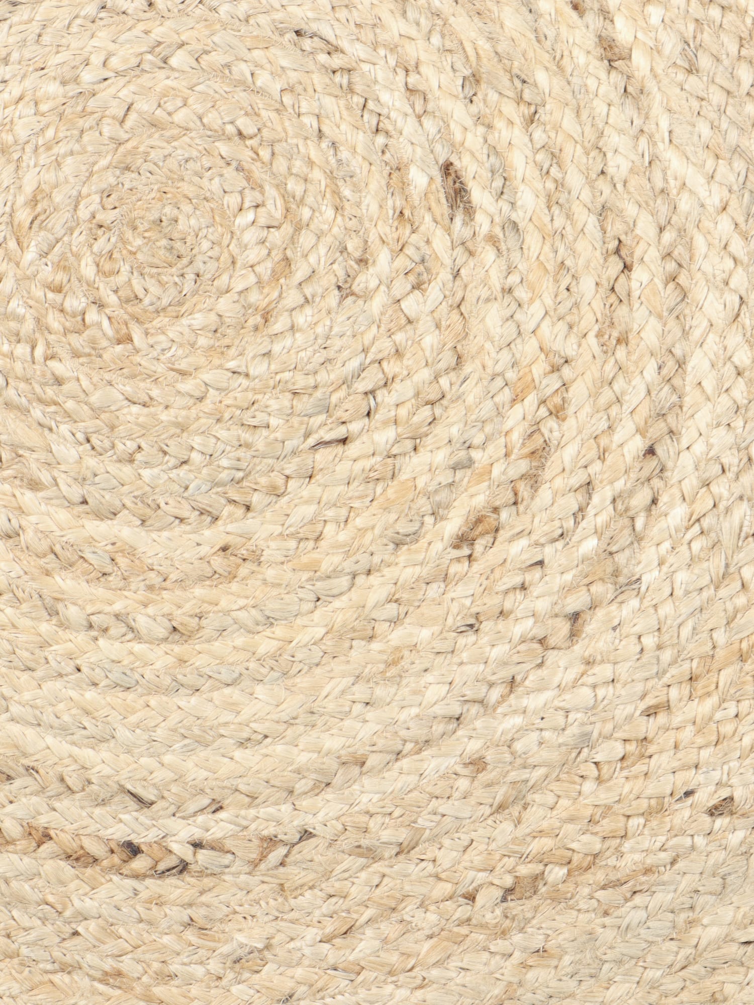 Close-up of concentric braided rings in natural-tan and cream tones on the round Savannah rug.