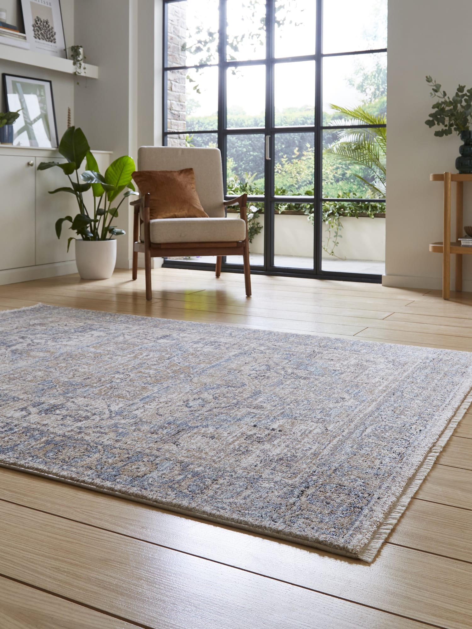 Vintage Medallion rectangular rug in blue, at a low angle beside glazed doors.
