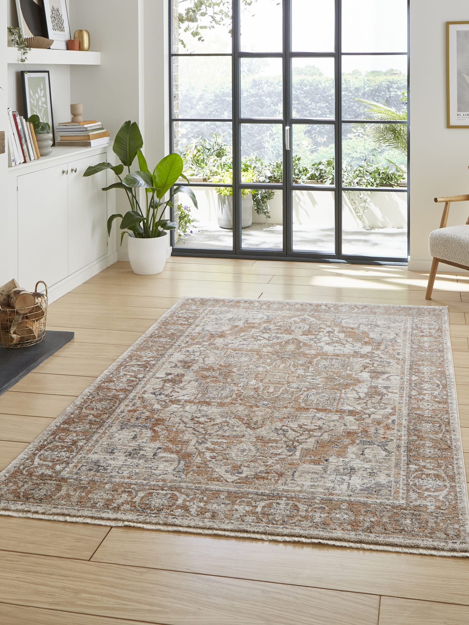 Vintage Medallion rectangular rug in terracotta, beside glazed doors on a wooden floor.