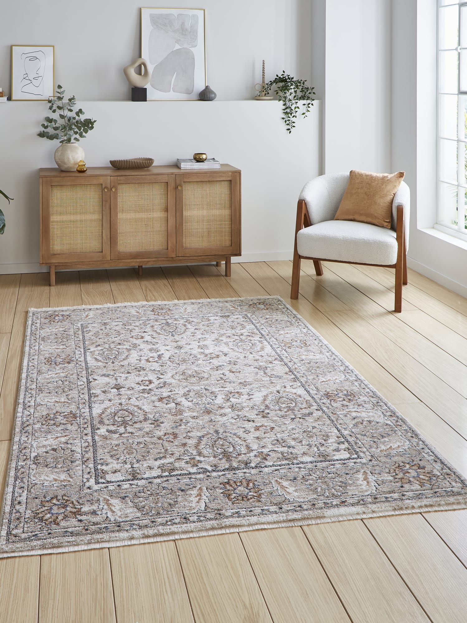 Vintage Ornamental rectangular rug in beige, beside an armchair and a wooden cabinet.